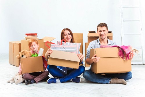 PPE-equipped moving team loading furniture into a van