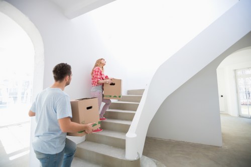 Professional movers carrying furniture in a Waterloo property